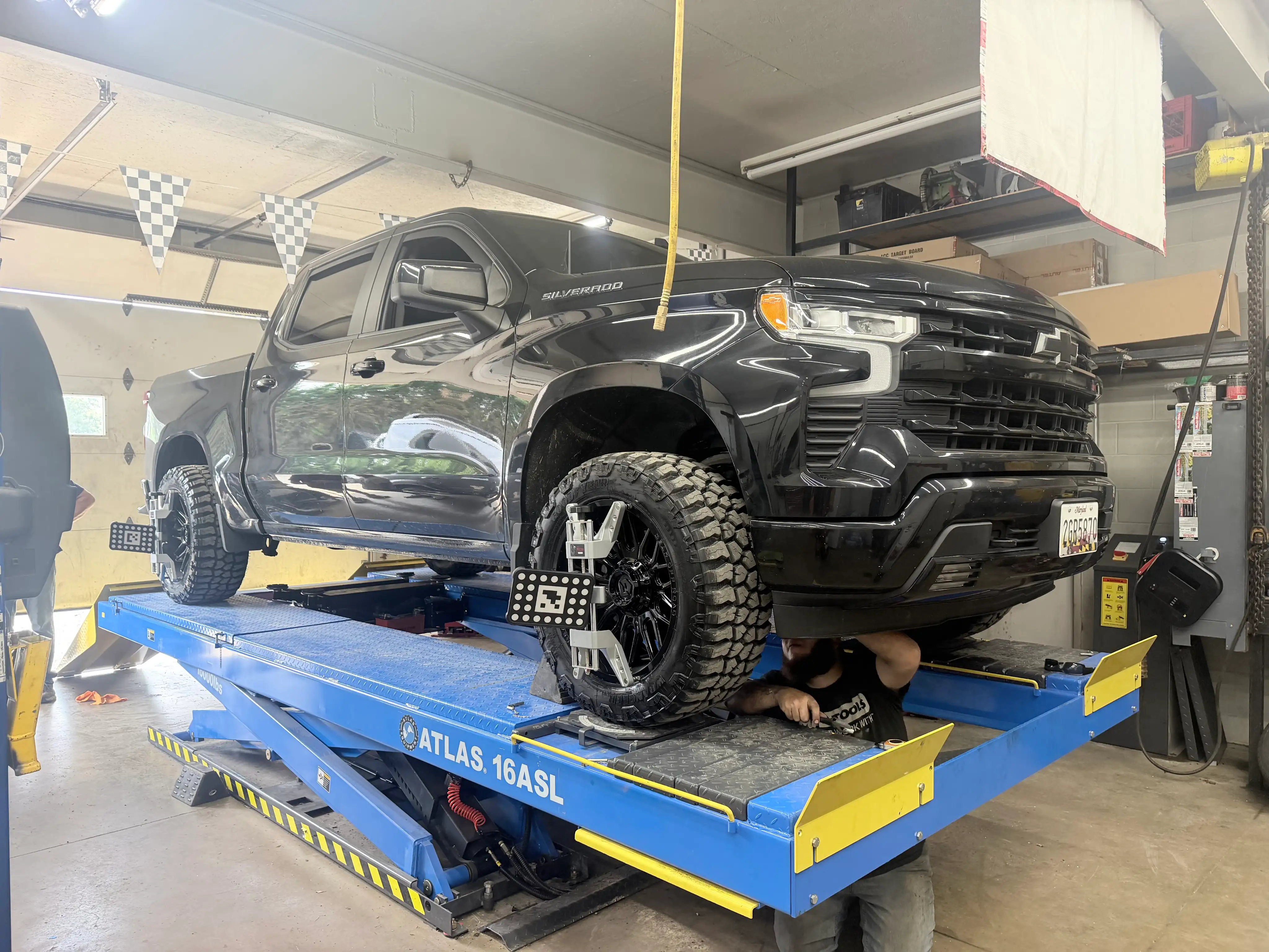 shues automotive repair working on wheel alignment