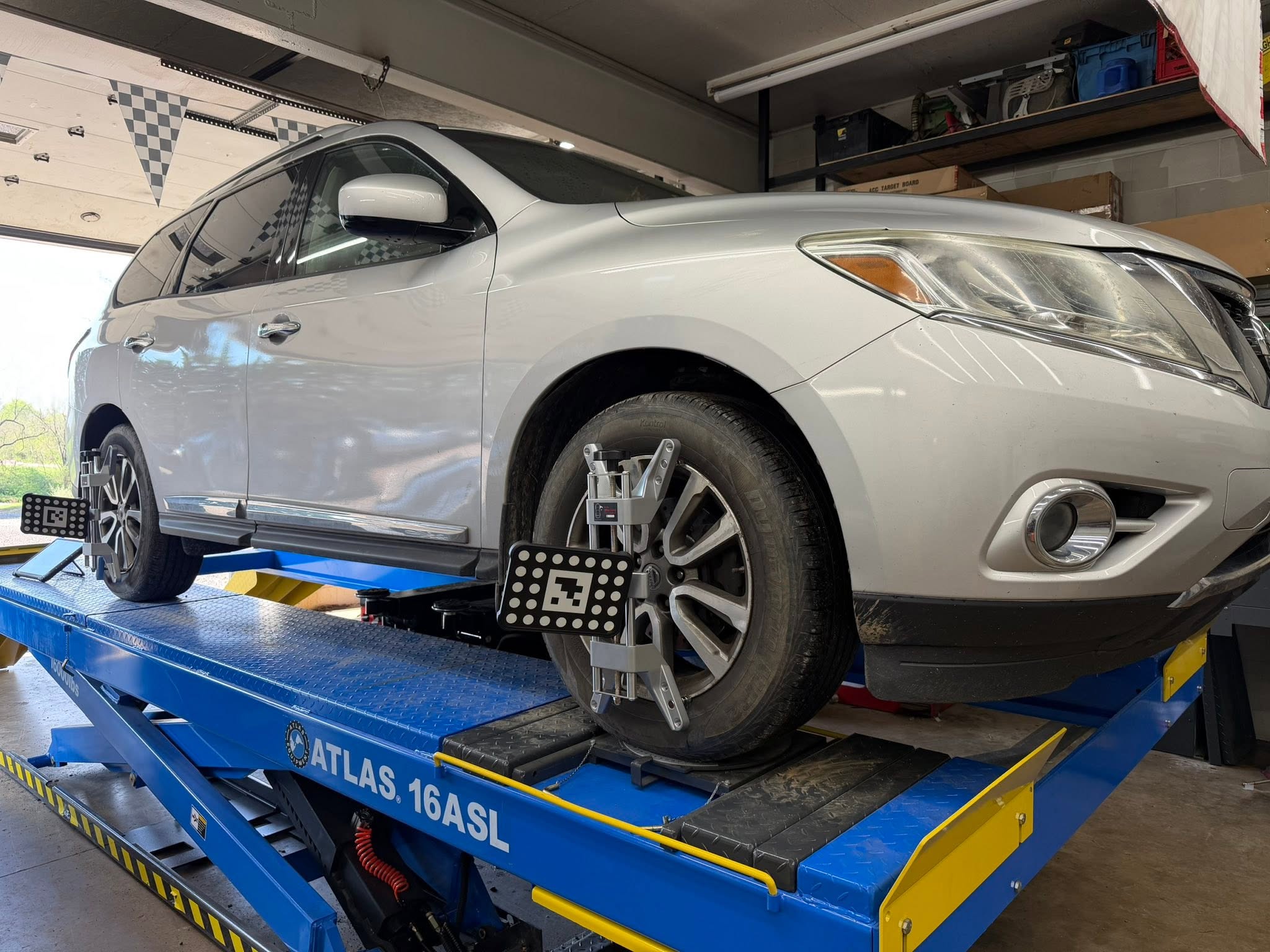 shue's automotive and towing performing front and rear wheel alignment with ADAS
